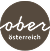 Logo von "oberösterreich" mit geschwungener, handgeschriebener Schrift auf dunklem Hintergrund.